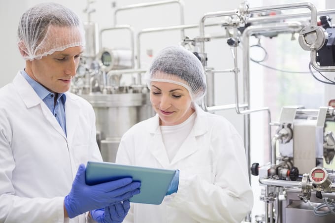 A food safety manager shows inspection logs to an auditor