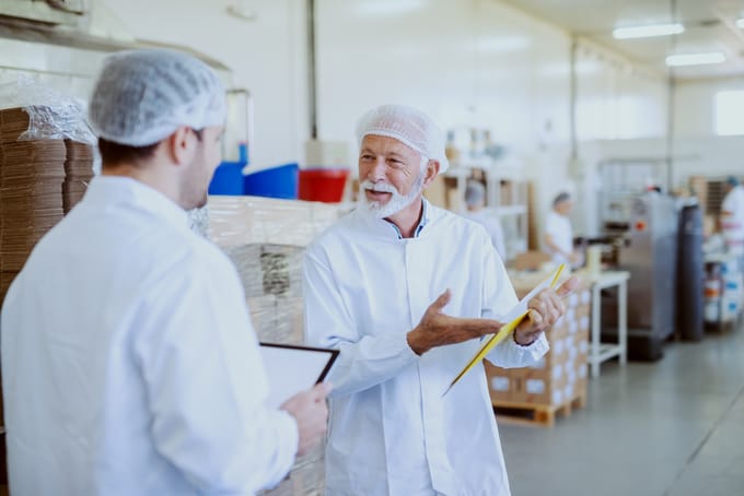 Two FSQA employees discuss food safety test results