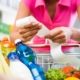 A woman checks her grocery receipt to see how much money she spent