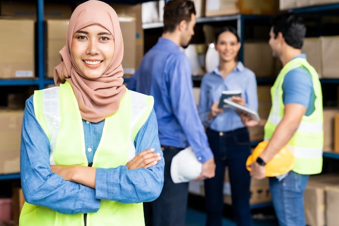 A team of distribution center employees discuss their quality control processes