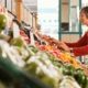 An older woman shops for peppers in her local grocery store