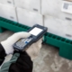 An employee scans a pallet of fruit in a distribution center