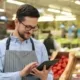 A grocery store employee using a tablet